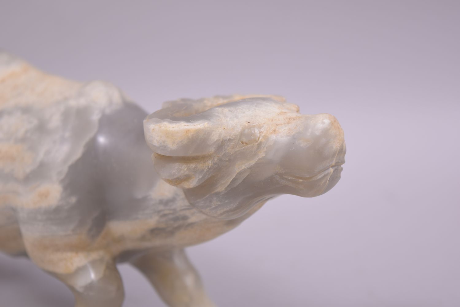 A CHINESE HARDSTONE OR WHITE JADE CARVING OF A BUFFALO, 23cm long. - Image 5 of 6