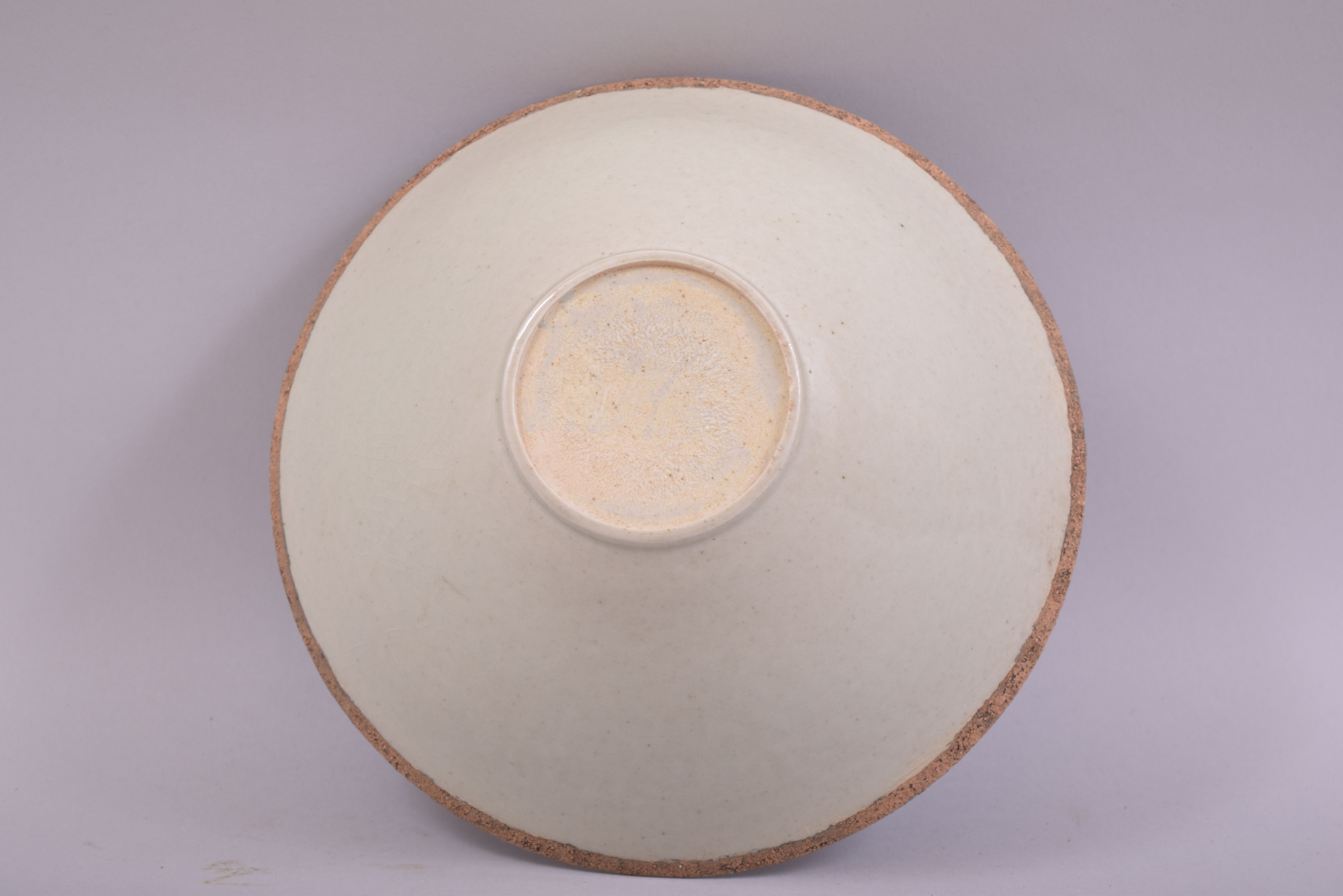 A CHINESE CELEDON GLAZED INCISED BOWL, the interior with carved floral decoration, 19.5cm diameter. - Image 3 of 3