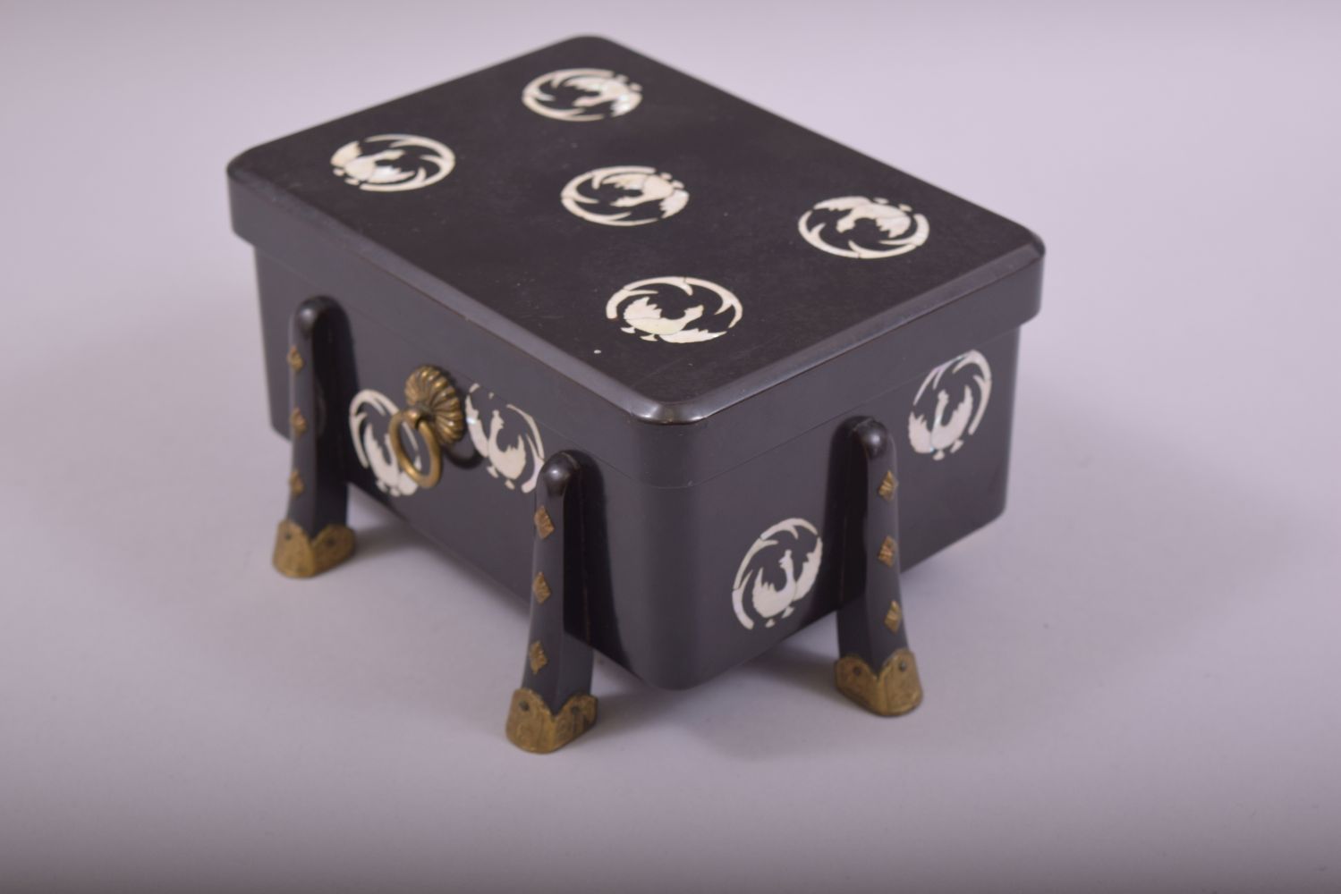 A JAPANESE BLACK LACQUER AND MOTHER OF PEARL INLAID BOX AND COVER, supported on eight feet with - Image 3 of 6