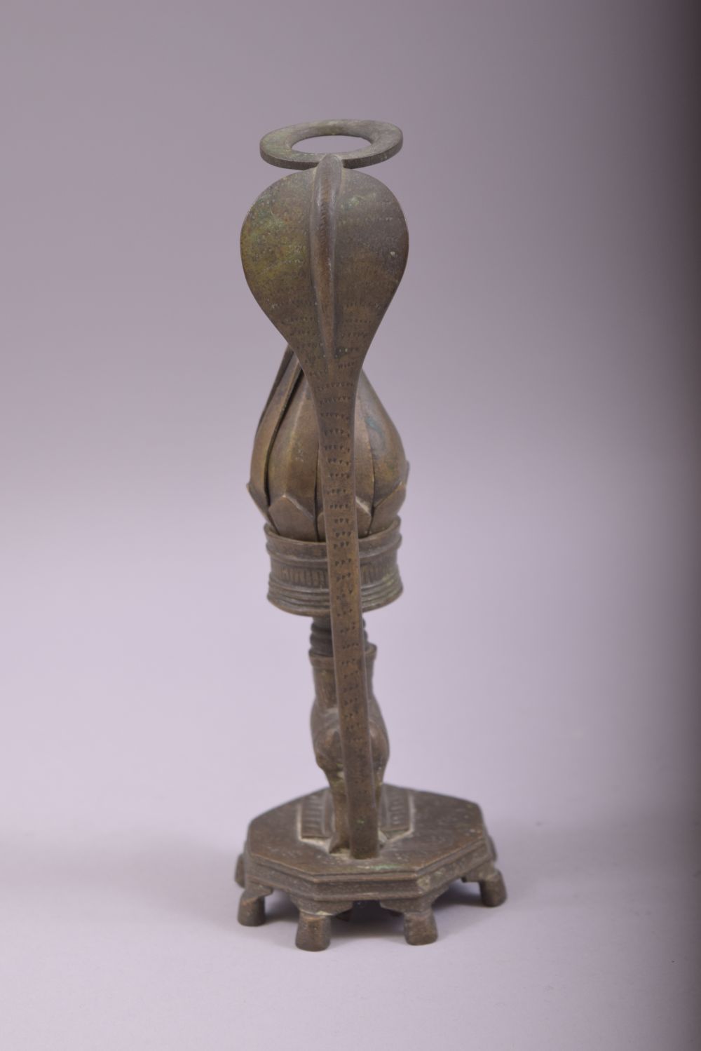 AN UNUSUAL INDIAN BRONZE CANDLESTICK, with reticulated petal formed cup, twisting the petals anti - Image 4 of 5