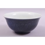 A CHINESE BLUE GLAZED PORCELAIN BOWL, with moulded decoration under glaze, six character mark to