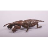 A JAPANESE BRONZE MODEL OF A MOLE CRICKET, stamped underside, 7cm long.