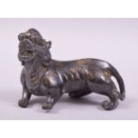 A CHINESE CAST METAL FIGURE OF A BEAST / FOO DOG, with speckled gilt to body, 11cm long.