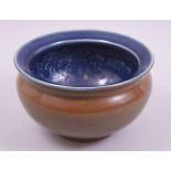 A CHINESE BROWN AND BLUE GLAZED POTTERY DRAGON BOWL, 19cm diameter.