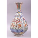 A CHINESE WUCAI OCTAGONAL FORM BALUSTER VASE, decorated with dragons and fish, with six character