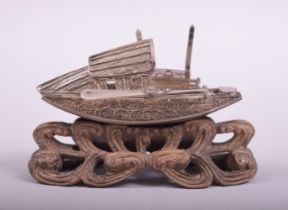 A SMALL CHINESE FILIGREE MODEL OF A JUNK, on a wooden stand, 7.5cm long.