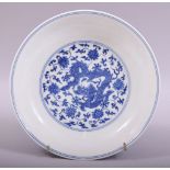 A GOOD CHINESE BLUE AND WHITE PORCELAIN DISH, the centre painted with a dragon amongst lotus and