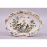A CHINESE FAMILLE VERTE OVAL SHAPED PORCELAIN DISH, painted with birds and flora, six character mark