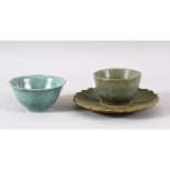 A CHINESE CELADON CUP AND SAUCER, together with a crackle ware cup (3).