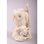 A SUPERB 19TH CENTURY JAPANESE CARVED IVORY OKIMONO of an owl and frog, the owl stood upon a