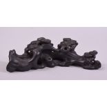 A CHINESE HARDWOOD CARVING, of naturalistic form, 20cm long.