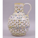 A TURKISH KUTAHYA GLAZED POTTERY WATER JUG, painted with foliate motifs, 20cm high.