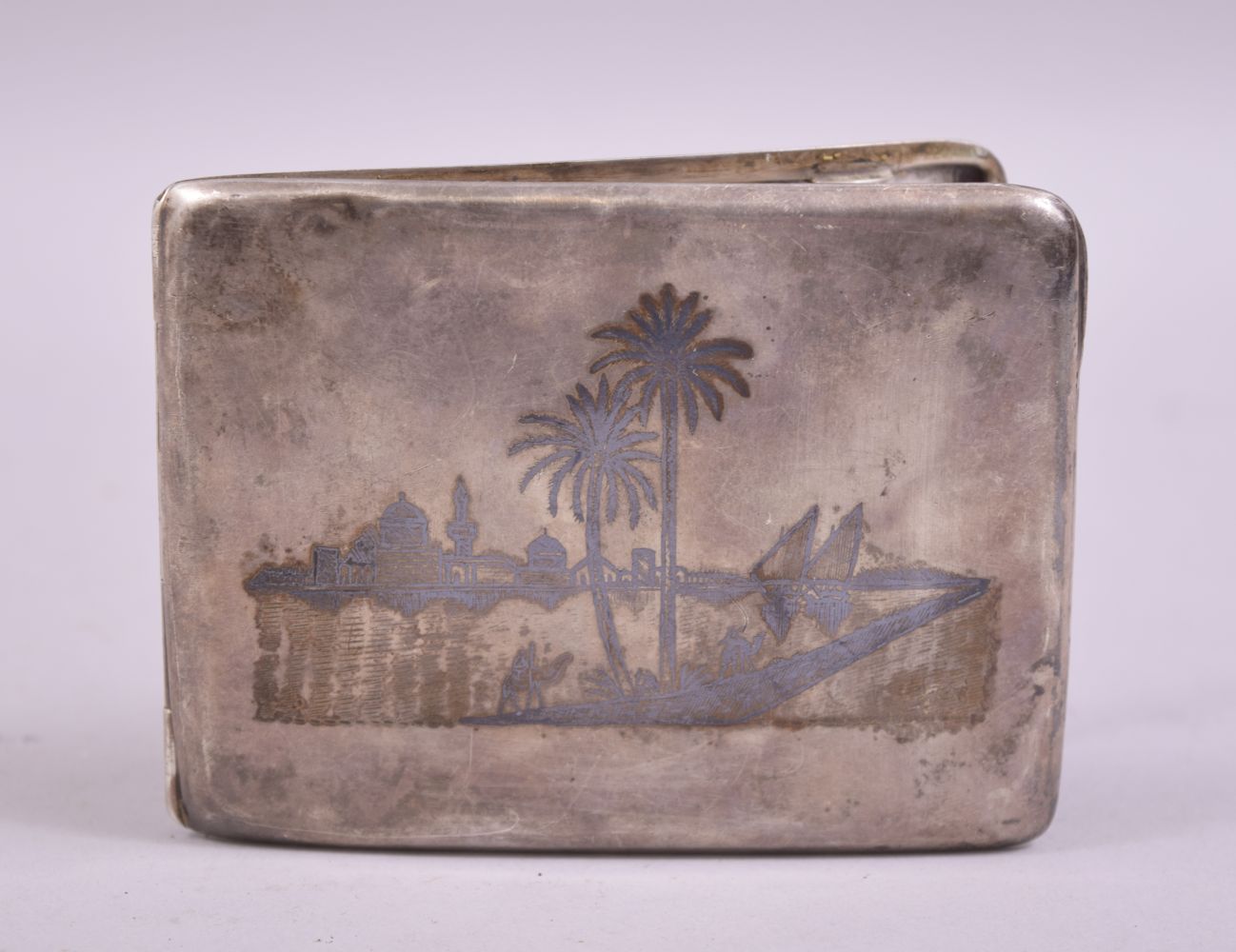 AN IRAQI NIELLO SILVER CIGARETTE CASE, inscribed on the reverse, 10.5cm x 8cm.