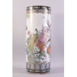 A CHINESE FAMILLE ROSE PORCELAIN WALKING STICK STAND, vividly decorated with peacocks amongst native