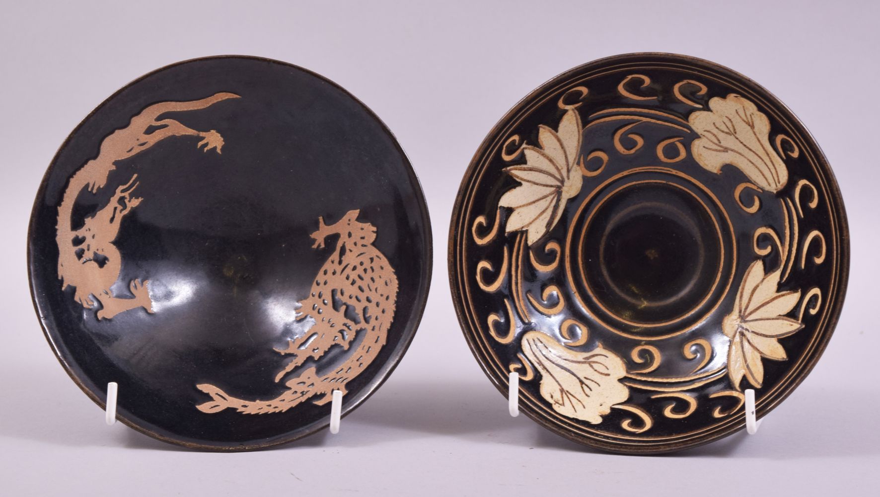 TWO CHINESE JIAN WARE BOWLS, one decorated with flower heads, the other with dragons, both 15cm
