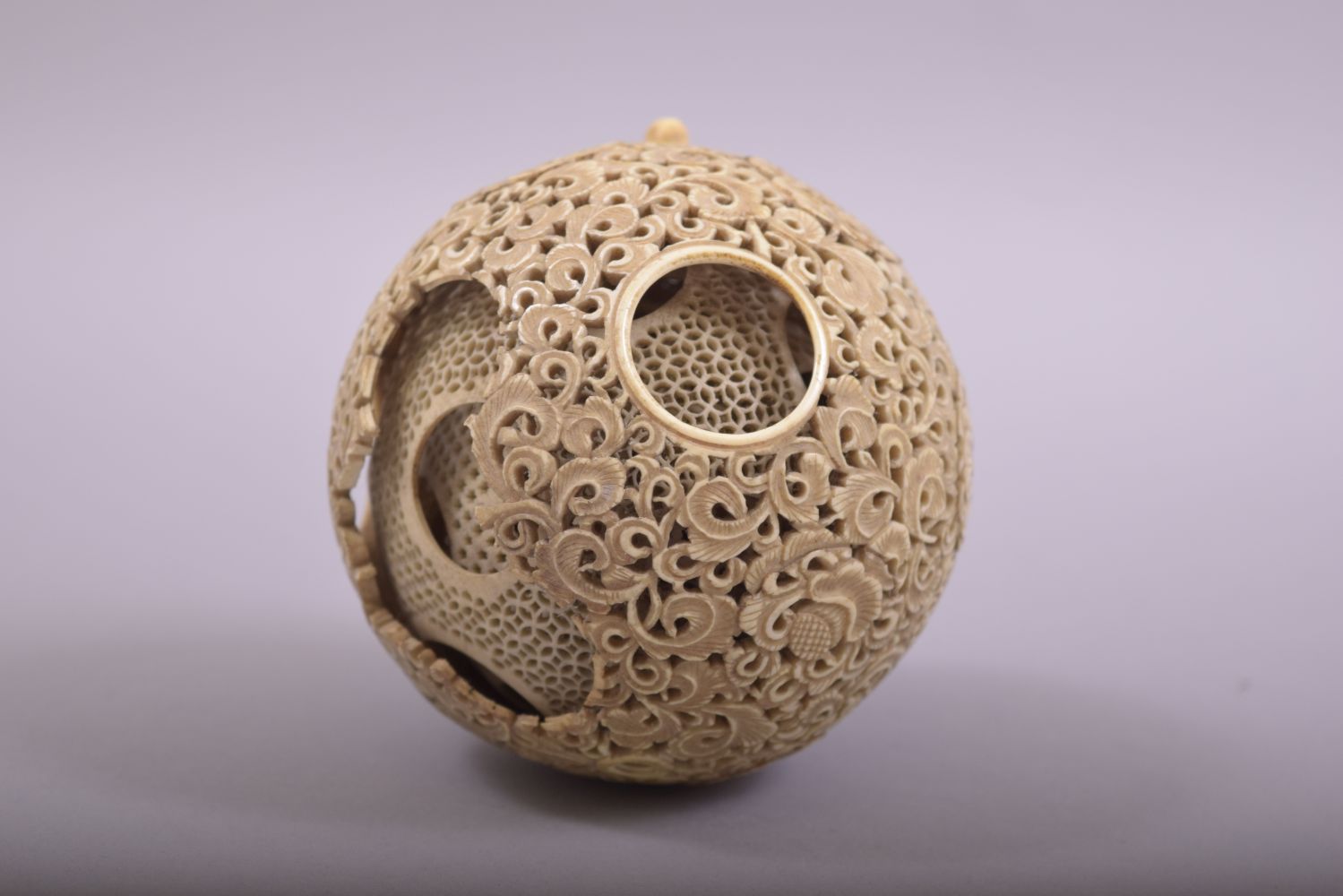 A CARVED AND PIERCED IVORY PUZZLE BALL, profusely pierced and carved with foliate design, approx. - Image 3 of 7