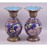 A PAIR OF CHINESE CLOISONNE VASES - with a deep royal blue ground depicting native flora and