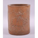 A CHINESER BAMBOO BRUSH POT, carved with a young boy on a water buffalo, 15.5cm high.