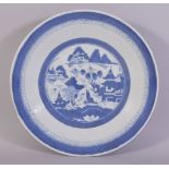 A CHINESE BLUE AND WHITE PORCELAIN DISH, the centre with a roundel containing a landscape setting,