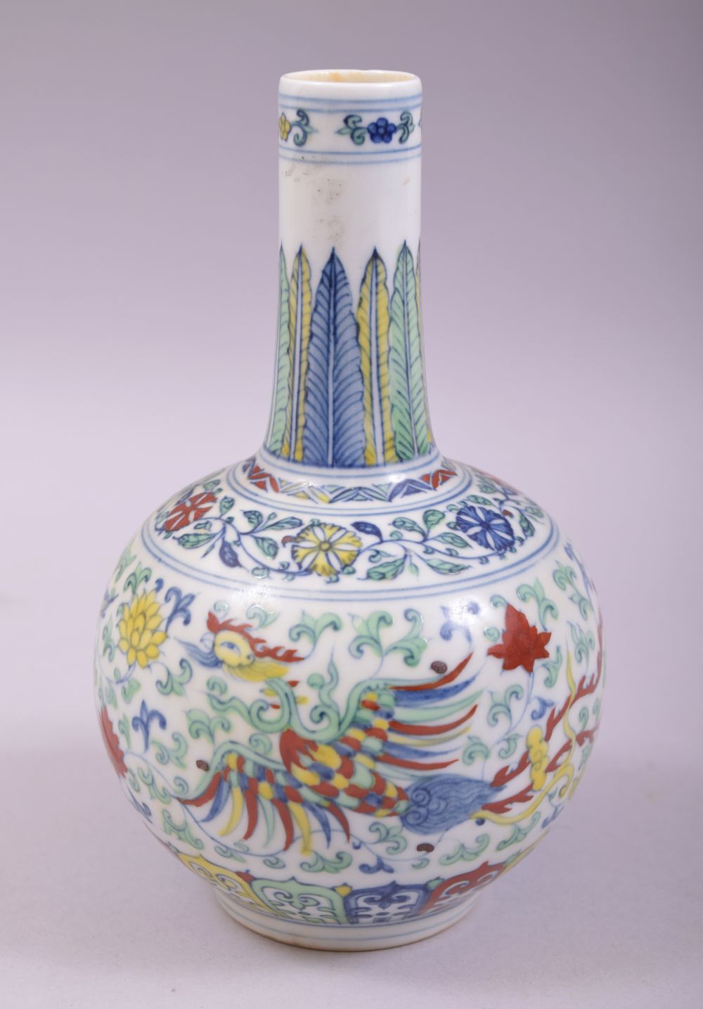 A SMALL CHINESE DOUCAI PORCELAIN BOTTLE VASE, painted in the doucai palette with a dragon and