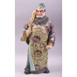 A JAPANESE KUTANI PORCELAIN FIGURE OF A WARRIOR holding a sword in his hand, 42cm high.