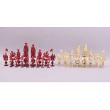 A GOOD 19TH CENTURY CHINESE CARVED AND STAINED RED AND WHITE IVORY CHESS SET, each piece on a carved