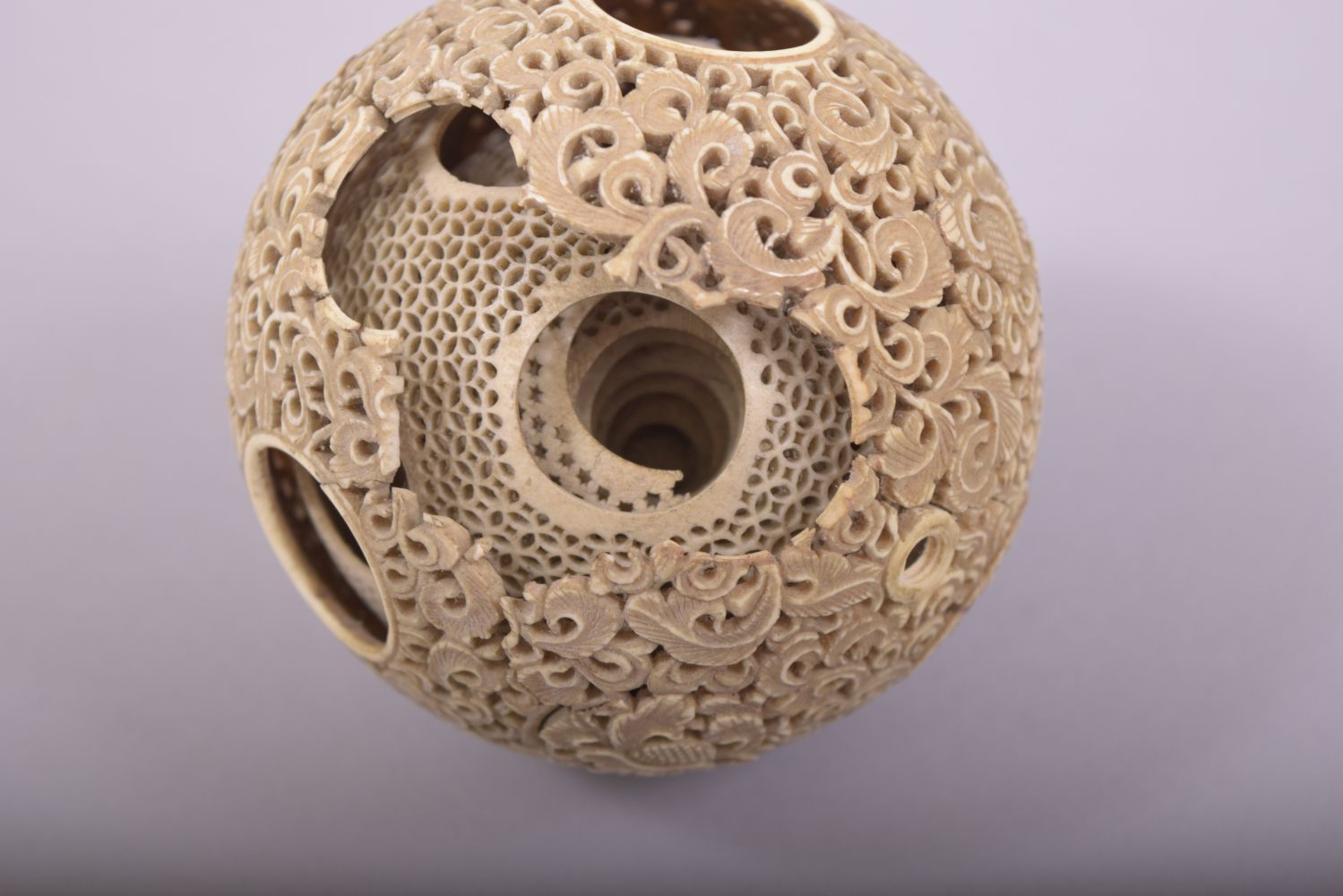 A CARVED AND PIERCED IVORY PUZZLE BALL, profusely pierced and carved with foliate design, approx. - Image 7 of 7