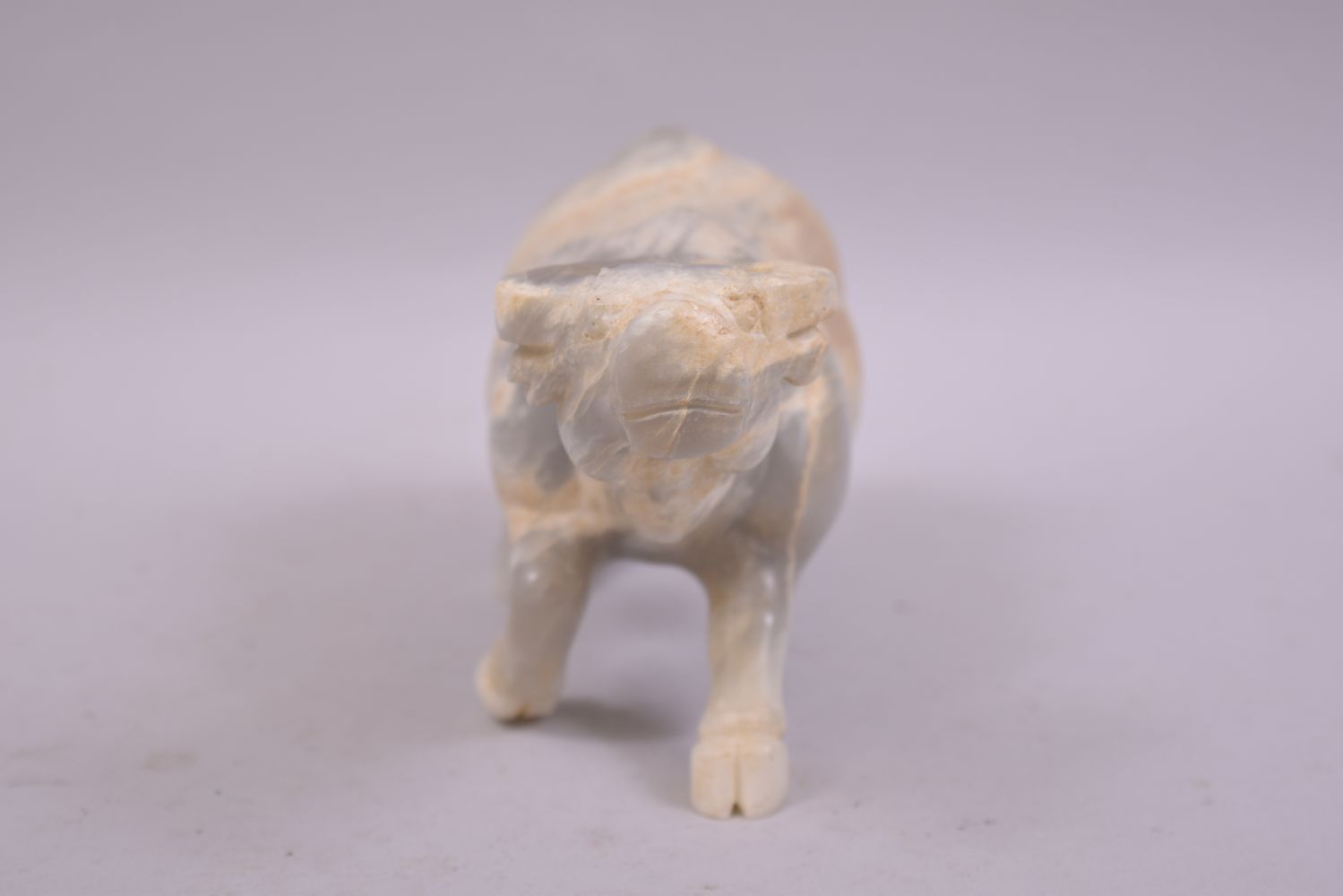 A CHINESE HARDSTONE OR WHITE JADE CARVING OF A BUFFALO, 23cm long. - Image 4 of 6