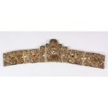 AN ISLAMIC FILIGREE BELT SECTION, with fine filigree work and inset with semi precious stones,