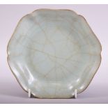 A CHINESE SONG STYLE CELADON LONGQUAN DISH, the base with calligraphy, 17.5cm diameter.