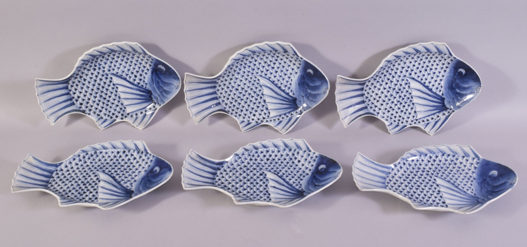 SIX CHINESE BLUE AND WHITE PORCELAIN FISH FORM DISHES, the dishes painted as fish, each dish with