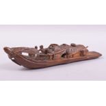 A CHINESE BAMBOO CARVING OF A BOAT, 22.5cm long.