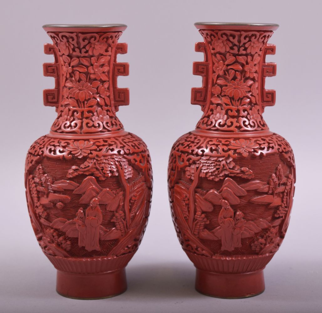 A SMALL PAIR OF CHINESE CINNABAR LACQUER TWIN HANDLE VASES, each with two panels depicting figures