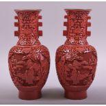 A SMALL PAIR OF CHINESE CINNABAR LACQUER TWIN HANDLE VASES, each with two panels depicting figures