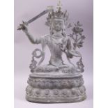 A LARGE BRONZE FIGURE OF A DEITY HOLDING A SWORD, 38cm high.