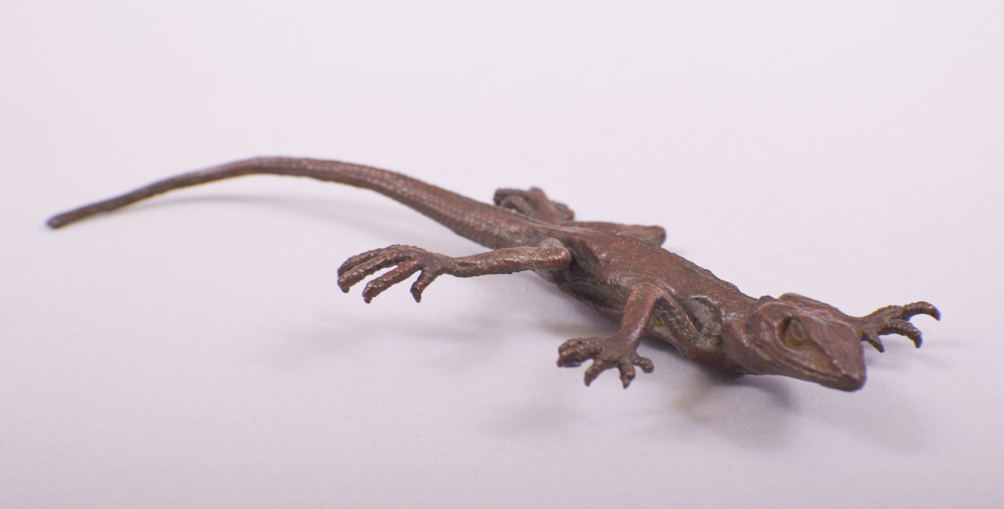 A JAPANESE BRONZE MODEL OF LIZARD, stamped underside, 16cm long.