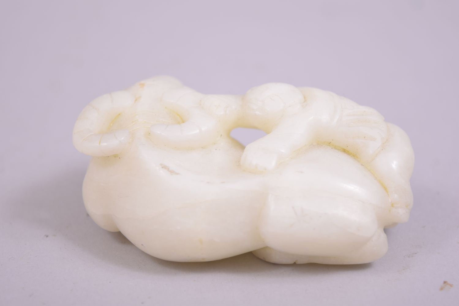 A SMALL CHINESE JADE CARVING OF A BUFFALO, with a figure astride, 8cm long. - Image 3 of 5