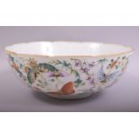 A LARGE CHINESE FAMILLE VERTE PORCELAIN BUTTERFLY DISH, the exterior profusely painted with