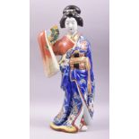 A JAPANESE ARITA PORCELAIN FIGURE, modelled as a geisha holding a fan, 46cm high.