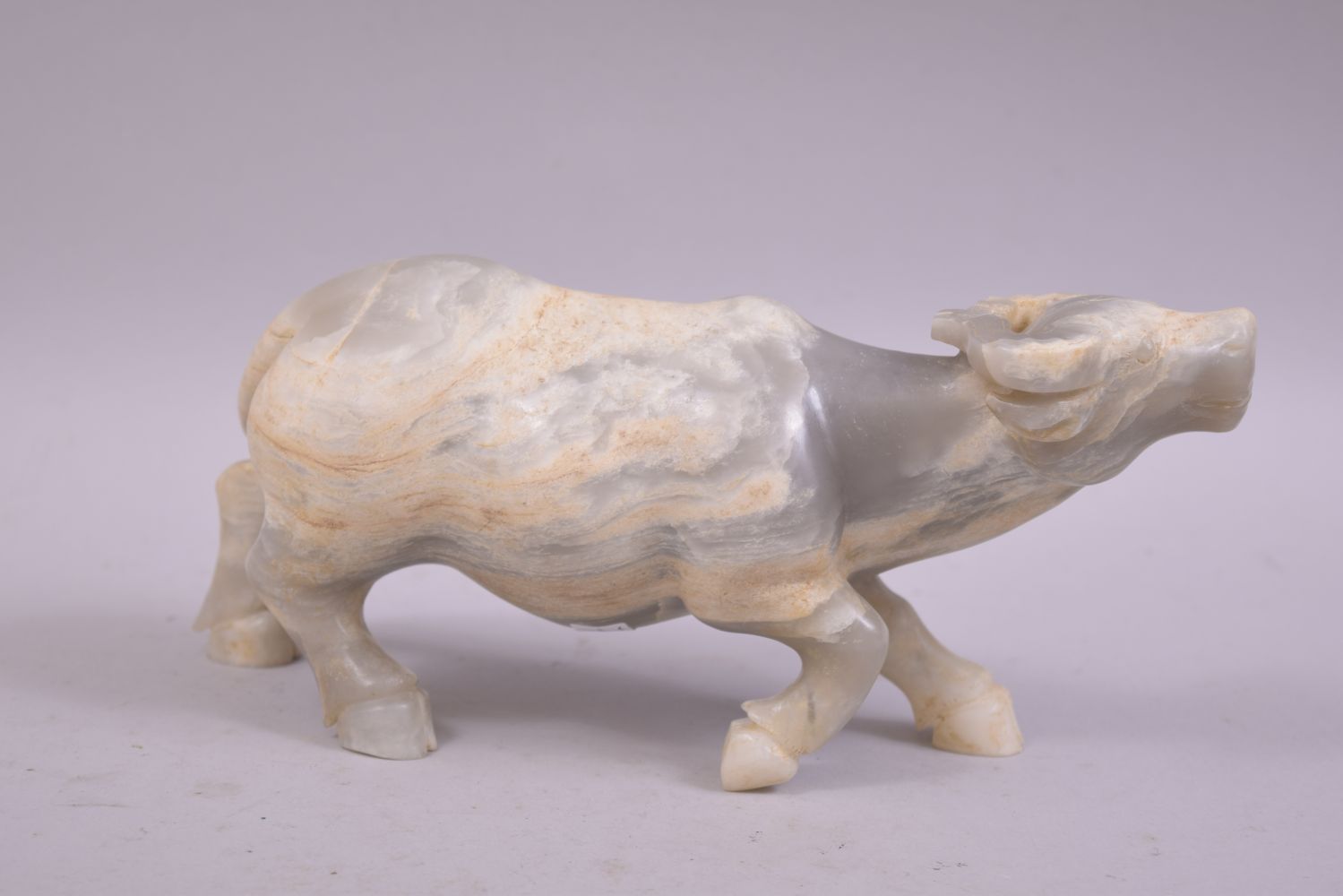 A CHINESE HARDSTONE OR WHITE JADE CARVING OF A BUFFALO, 23cm long. - Image 2 of 6