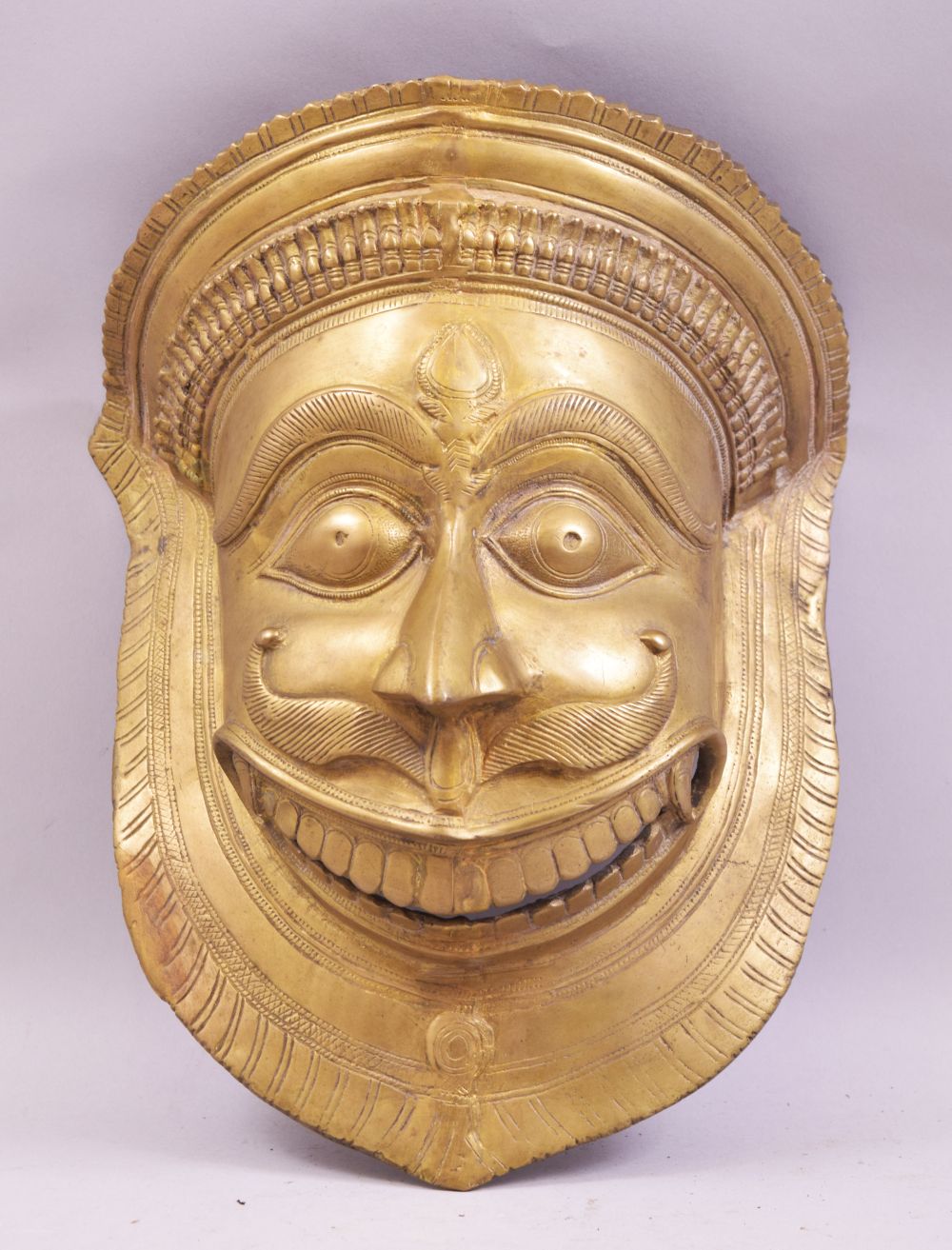 A LARGE 19TH CENTURY INDIAN BRONZE WALL MASK OF NARASIMHA / MAN LION; a fierce avatar of the Hindu