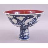 A CHINESE BLUE AND WHITE PORCELAIN STEM CUP, the exterior decorated with fish and flora, the