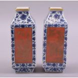 A PAIR OF SMALL CHINESE BLUE, WHITE AND CORAL RED SQUARE FORM VASES, each side with a panel of