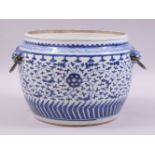 A CHINESE BLUE AND WHITE PORCELAIN BOWL, with twin mask and wire work handles, the body painted with