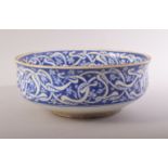 A TURKISH OTTOMAN IZNIK BLUE AND WHITE GLAZED POTTERY BOWL, decorated with bands of intertwined
