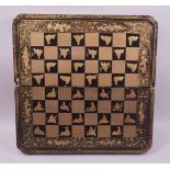 A VERY GOOD 19TH CENTURY GILT AND LACQUERED FOLDING CHESS BOARD, interior with backgammon board,