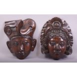 A PAIR OF BEAUTIFULLY CARVED WOODEN INDONESIAN MASKS of a male and female with head dress, the