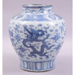 A CHINESE BLUE AND WHITE PORCELAIN JAR, painted with dragons and the flaming pearl of wisdom amongst