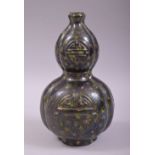 AN UNUSUAL CHINESE FAMILLE NOIR GOURD VASE, baring the symbol of longevity and decorated with a