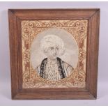A WOOLWORK TAPESTRY BUST LENGTH PORTRAIT of a male Arab youth in a moulded oak frame, image size